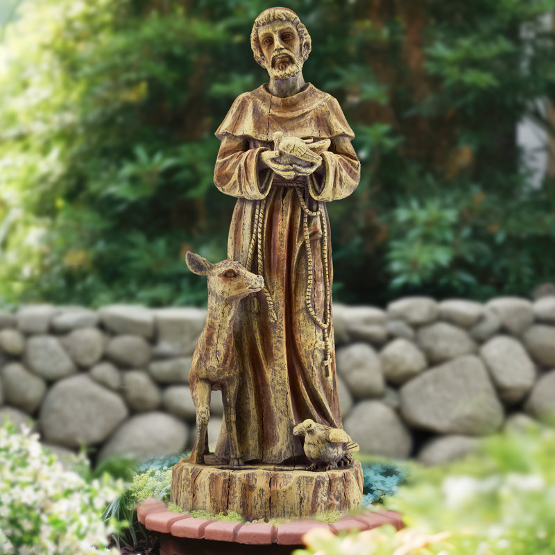 Statue de jardin religieuse représentant saint François, le protecteur de la nature avec mangeoire à oiseaux