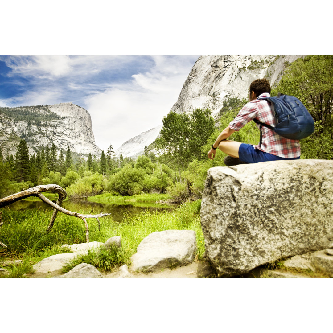 Mann sitzt auf Felsen in Yosemite von Orbon Alija - Drucken