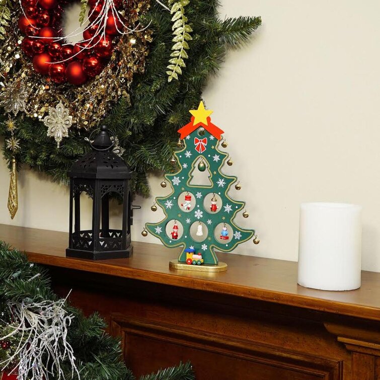 Cone Shape Cut Out Wooden Mini Christmas Tree Is Painted With Green  Patterns Tiny Christmas Ornaments Are Hanging On Small Table Size Christmas  Tree Winter Holiday Decoration New Year Attributes Stock Photo 