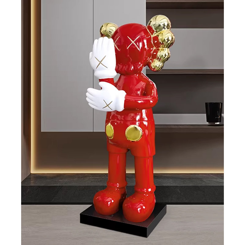 KAWS - Inspired large black and gold resin sculpture with plated details and marble base, 29.1" H x 11" W x 10.2" D, Red