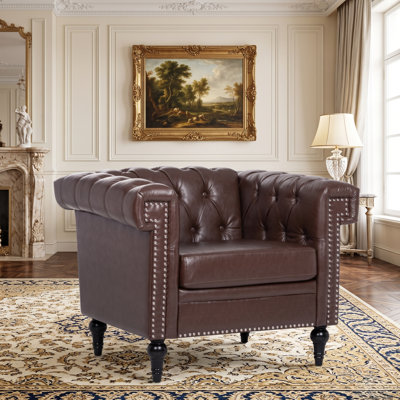 Fauteuil club Chesterfield en similicuir capitonné avec garniture cloutée
