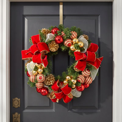 Festive Gold and Red Holiday Wreath with Ornaments and Ribbons.