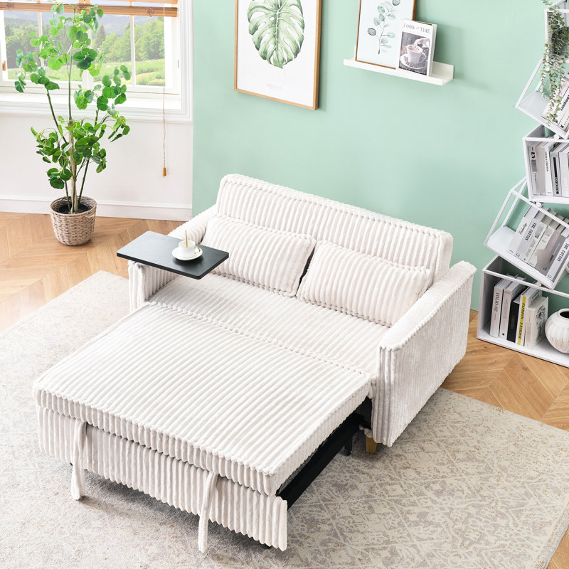 Velours côtelé beige confortable avec bureau mobile et écran, idéal pour les espaces de détente et de travail, créant un environnement de vie confortable