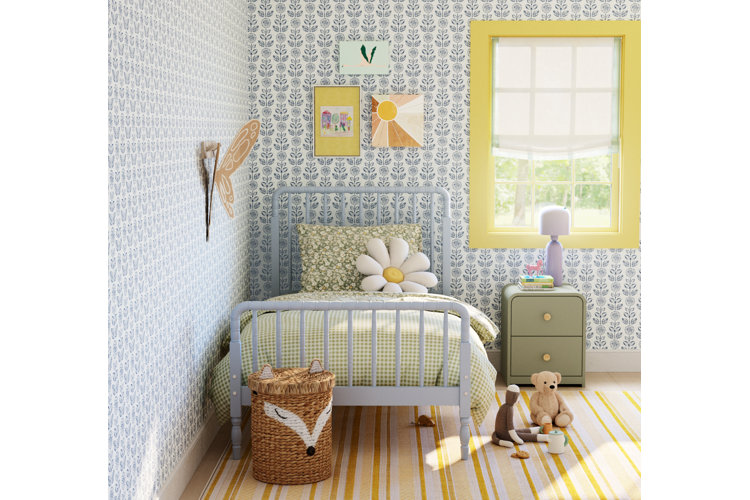 cottage core children’s room with a spindle kids bed and blue floral wallpaper