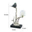 Figurine oiseau sur une branche-408830220