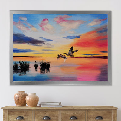 Grues volant pendant un coucher de soleil coloré - peinture sur toile