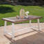 Table de salle à manger d'extérieur en bois d'acacia à finition sablée avec structure en métal rustique