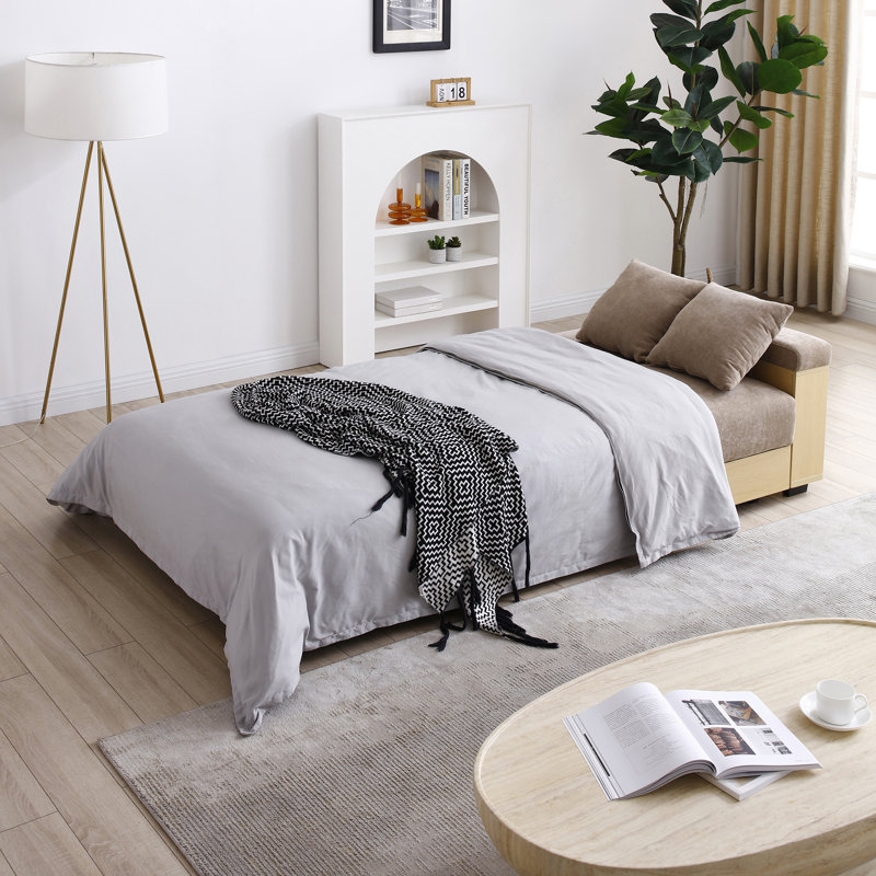 Canapé-lit convertible avec repose-pieds, table rabattable et accoudoirs réversibles pour une utilisation polyvalente dans les salons et les appartements