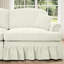 Canapé trois places de style années 50 avec accoudoirs évasés, jupe à volants amovible et plissée, tissu chenille beige et blanc, confortable, modulable et détachable.