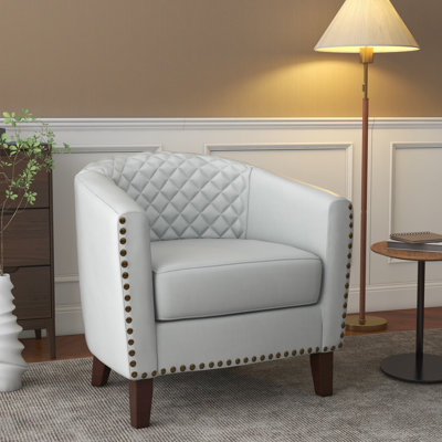 Fauteuil demi-tonneau capitonné en similicuir Edvardas