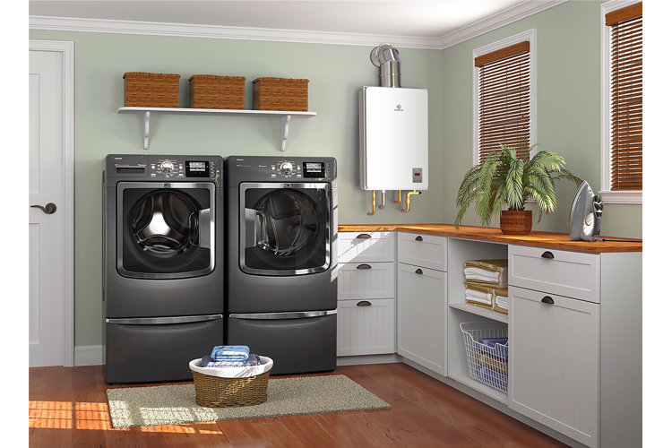 laundry room with a water heater above the washer and dryer
