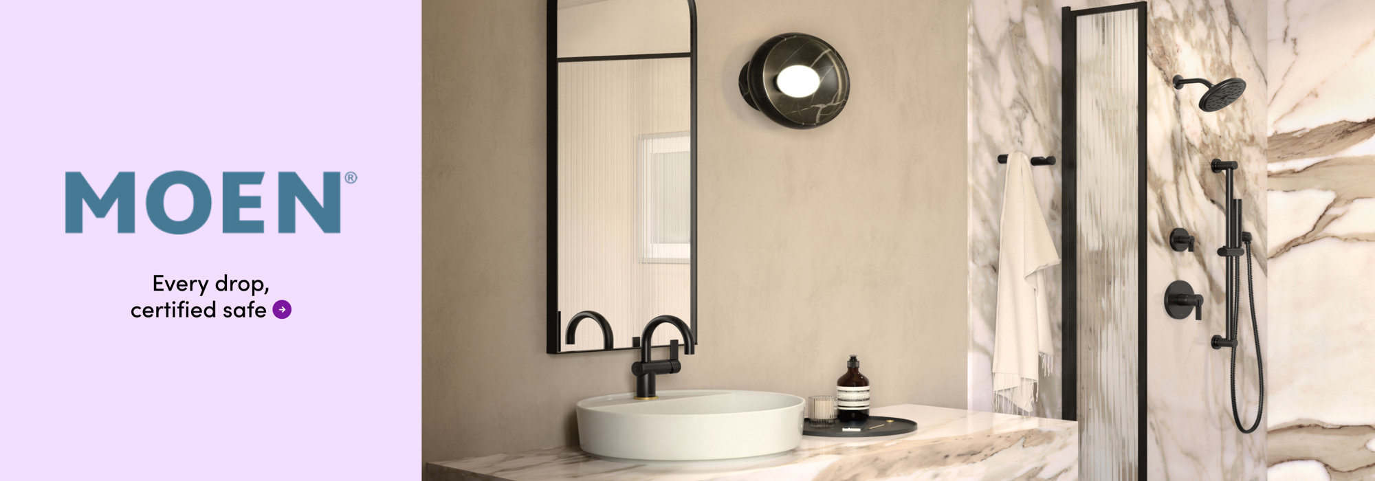 Moen: Every drop, certified safe. A stylish bathroom vanity with a modern black faucet, matching mirror, and lighting.