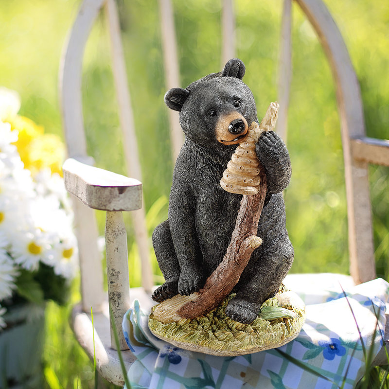 Figurine miel et ours noir curieux