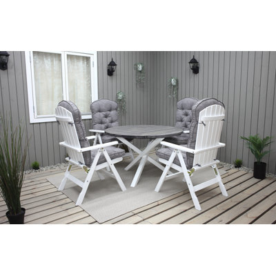Capuano 4 - Person Wood Patio Dining Set with Round Table , Cushions Included