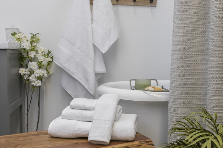 white bath tub with towels