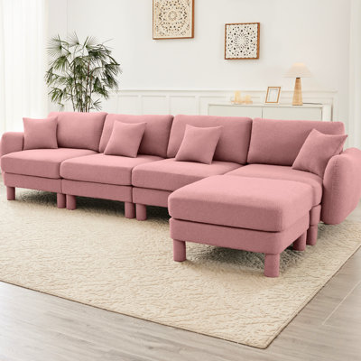 Canapé convertible en L rose à 4 places en tissu bouclé avec pieds en forme de coquillage, amovibles et cylindriques. Structure de sièges confortables pour le salon avec des espaces de confort de conception moderne