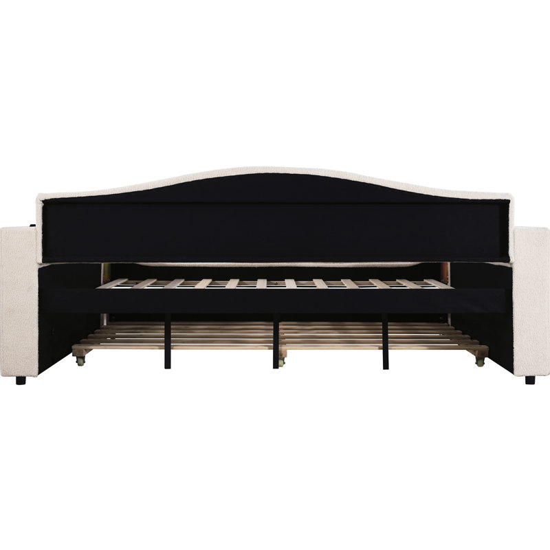 Lit de jour en molleton beige avec compartiment de rangement, lit gigogne et options de divertissement, système de musique intégré