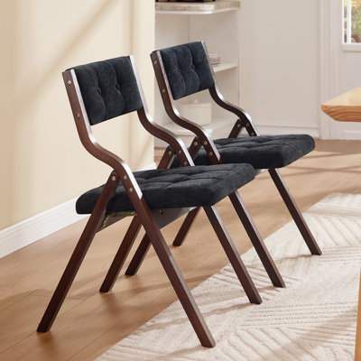Chaise pliante au design élégant avec structure en bois massif et dossier et siège rembourrés capitonnés