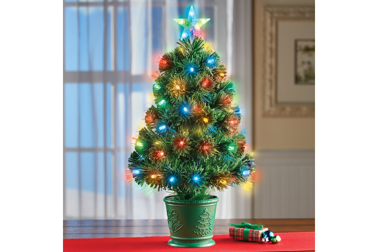 miniature lighted christmas tree on a table