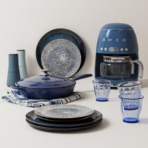 Smeg coffee maker, Tramontina frying pan, glasses, and plates.