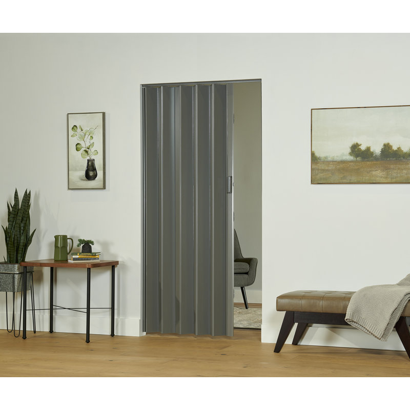 Grey PVC accordion door with vertical panels installed in a residential doorway.