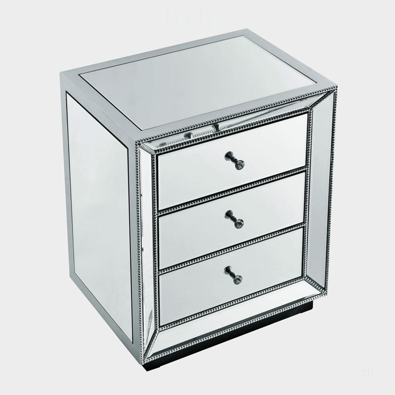 Meuble à trois tiroirs avec fini miroir perlé, idéal pour un rangement élégant et une utilisation multifonctionnelle dans les maisons modernes.