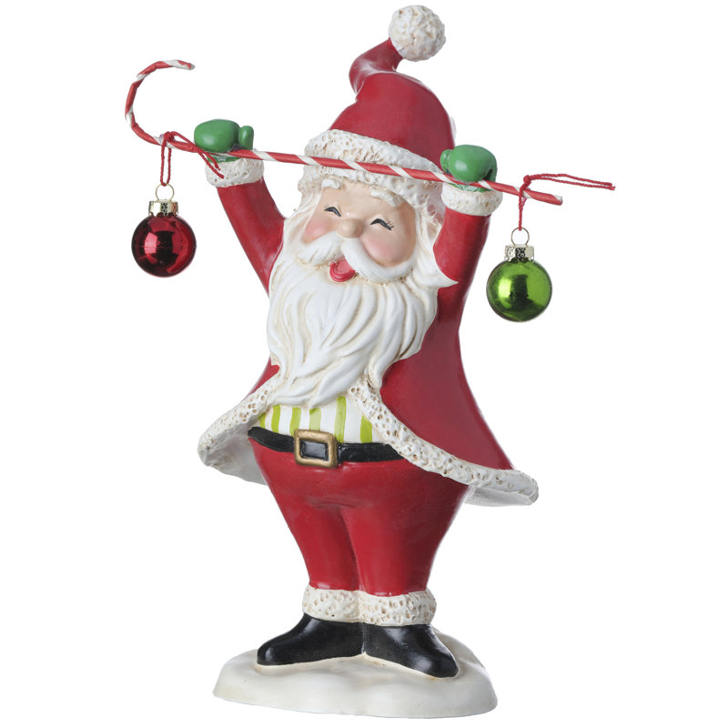 Figurine de père Noël tenant une canne en bonbon avec boules