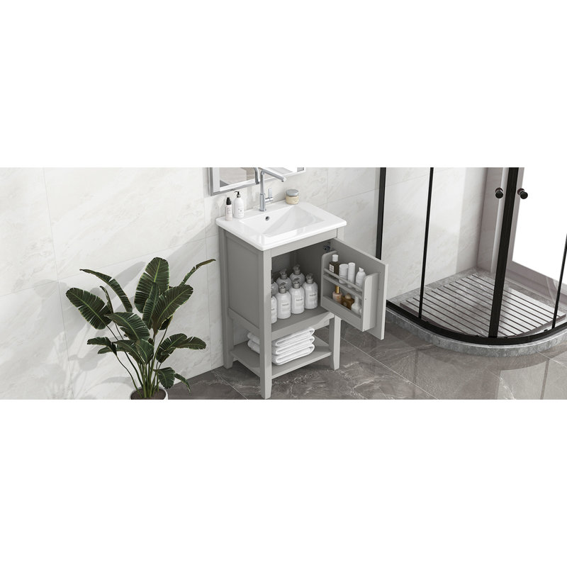 Meuble-lavabo gris avec lavabo de 50 cm, en bois massif, avec tablette de rangement et design pratique.