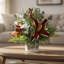 Festive holiday arrangement with greens and Berries