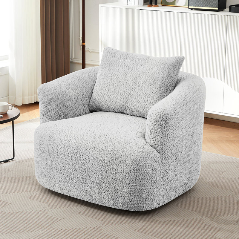 Fauteuil pivotant rembourré en tonneau avec coussin décoratif
