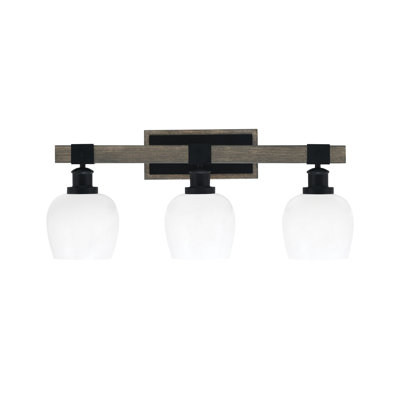 Barre d'éclairage de salle de bain 3 lumières Bitner présentée en noir mat et finition en métal d'aspect bois patiné avec verre marbré blanc de 6 po
