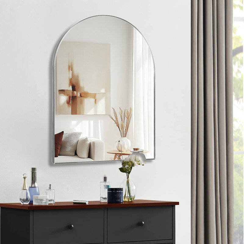 Miroir de salle de bain arqué en métal argenté pour mur, rehaussant l'élégance et la clarté des reflets dans les salles de bain modernes.