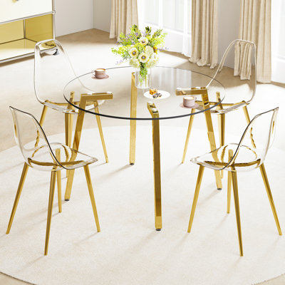 Table de salle à manger transparente en verre trempé avec pieds en métal doré et 4 chaises confortables en plastique