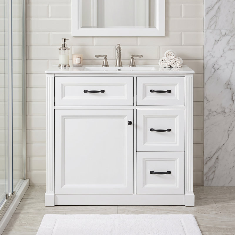 Meuble-lavabo autoportant blanc à un lavabo de 91 cm (36 po), avec comptoir en céramique et porte d'armoire à fermeture amortie.