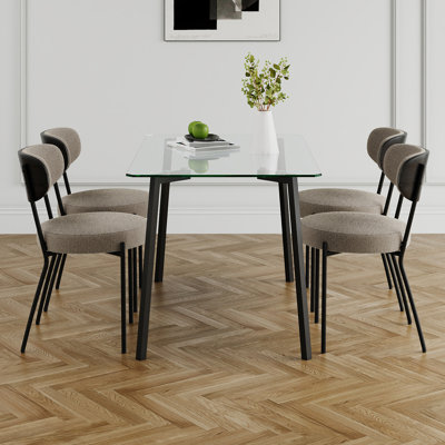 Table moderne simple avec une table rectangulaire en verre et quatre chaises. Comptoir en verre trempé transparent