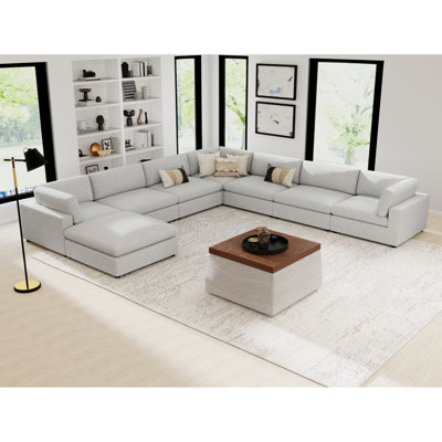 Canapé d'angle moderne minimaliste de 8 pièces avec pouf, revêtement souple et tissu d'ameublement.