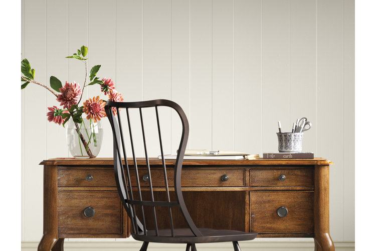 traditional-style writing desk and a black windsor chair