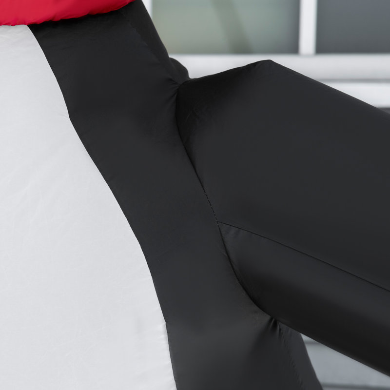 Pingouin tenant une canne de Noël gonflable