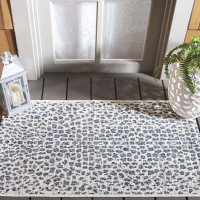 Tyron Animal Print Ivory/Navy Area Indoor/Outdoor Area Rug