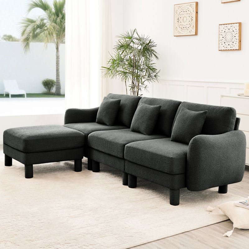 3 places en tissu bouclé gris foncé en forme de L avec des pieds amovibles, distinctifs et cylindriques, un attrait moderne pour le bureau modulaire convertible en forme de coquillage, pour un salon chaleureux et accueillant