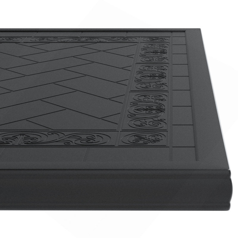 Table de salle à manger en fonte d'aluminium avec cadre noir et texture sculptée sur le plateau de table