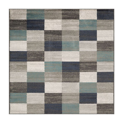 Tapis géométrique bleu et gris tissé à la machine