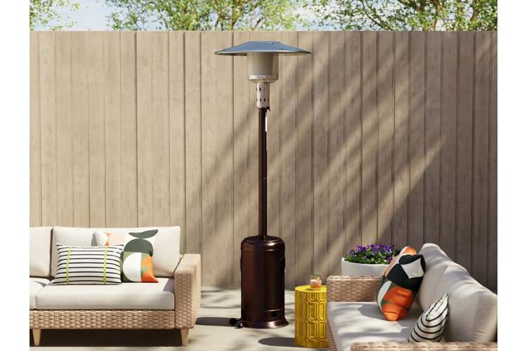 beautiful outdoor dining space at night with a patio heater and set of twinkling string lights