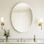 Un miroir de salle de bain ovale sans cadre, moderne et élégant, idéal pour les salles de bain, les chambres à coucher, les coiffeuses et les vestibules.