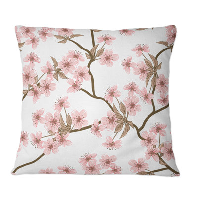 Coussin rose à motif de fleurs de cerisier roses sur fond blanc