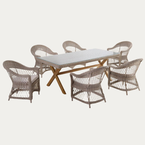Wicker outdoor dining set with six chairs and a glass top table.