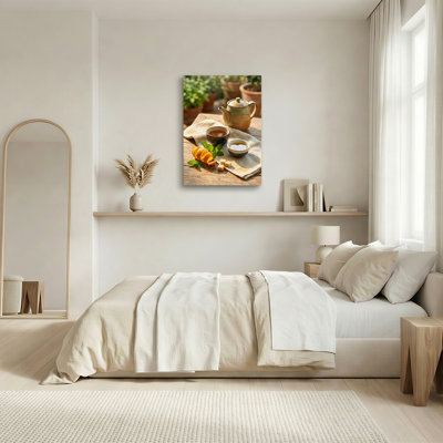 Théière en céramique avec tranches d'orange et feuilles de menthe sur toile