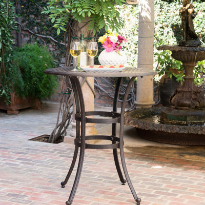 Table de bar traditionnelle en fonte d'aluminium avec plateau de couleur bronze foncé, aspect rouille, porte-parapluie central, 96,5 cm (L) x 96,5 cm (P), structure et insert, 94 cm de large x 105,4 cm de hauteur
