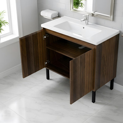 Freestanding bathroom vanity with a ceramic sink, soft-close doors, and built-in shelves