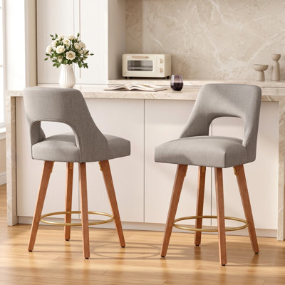 Tabouret de comptoir pivotant rembourré en lin avec structure en bois massif et repose-pieds